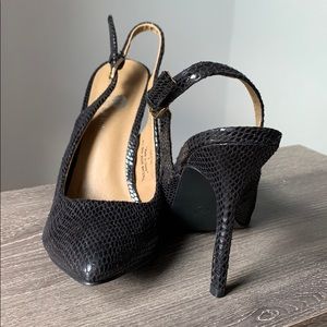 Black animal print heels by Riverberry